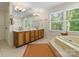 Bathroom featuring a large soaking tub, double sink vanity and natural lighting at 273 S Downs Way, Fort Mill, SC 29708