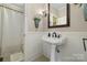 Bathroom with a pedestal sink, decorative mirror, wainscotting and view of shower at 273 S Downs Way, Fort Mill, SC 29708