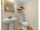 Bathroom with a pedestal sink and toilet, featuring neutral paint, mirror, and tiled floor at 273 S Downs Way, Fort Mill, SC 29708