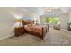 Bedroom featuring large window for natural light, nightstands and two upholstered chairs at 273 S Downs Way, Fort Mill, SC 29708