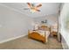 Bedroom featuring a ceiling fan, large window for natural light and decorative accent wall at 273 S Downs Way, Fort Mill, SC 29708