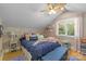 Charming bedroom with wood accents, sloped ceilings, and a bright window at 273 S Downs Way, Fort Mill, SC 29708