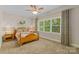 Bedroom featuring a ceiling fan, large window for natural light and decorative accent wall at 273 S Downs Way, Fort Mill, SC 29708