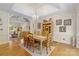 Bright dining room with elegant chandelier, hardwood floors, and wooden table with seating for six at 273 S Downs Way, Fort Mill, SC 29708