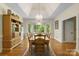 Elegant dining room featuring tray ceilings, large windows, and hardwood floors at 273 S Downs Way, Fort Mill, SC 29708