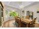 Bright dining room with large bay windows, hardwood floors, and a chandelier at 273 S Downs Way, Fort Mill, SC 29708