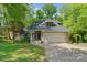 Charming home featuring a two-car garage, front porch, and mature trees in a desirable neighborhood at 273 S Downs Way, Fort Mill, SC 29708