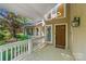 Inviting front porch with brick flooring, white railing, and natural lighting at 273 S Downs Way, Fort Mill, SC 29708