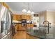 A well-lit kitchen featuring stainless steel appliances, custom cabinets, and a granite-topped island with seating at 273 S Downs Way, Fort Mill, SC 29708