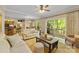 Bright open-concept living room seamlessly connects to the kitchen, dining area, and outdoor deck through sliding doors at 273 S Downs Way, Fort Mill, SC 29708