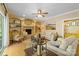 Cozy living room with stone fireplace, built-in shelving, hardwood floors, and comfortable seating arrangements at 273 S Downs Way, Fort Mill, SC 29708