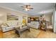Spacious living room with hardwood floors, fireplace, and seamlessly connected to the kitchen and dining areas at 273 S Downs Way, Fort Mill, SC 29708