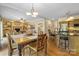 Bright living space featuring an open design, hardwood floors, adjacent kitchen, and a fireplace at 273 S Downs Way, Fort Mill, SC 29708