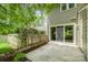View of the backyard with patio, siding, white door, and a brick chimney at 2756 Von Thuringer Ct, Charlotte, NC 28210