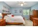 Comfortable bedroom with natural light, wooden furniture, and decor on the blue walls at 2756 Von Thuringer Ct, Charlotte, NC 28210