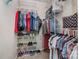 Organized walk-in closet with racks and shelves for clothing and accessories at 2756 Von Thuringer Ct, Charlotte, NC 28210