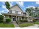 Beautiful two-story home with a covered front porch, complemented by lush landscaping and a well-manicured lawn at 2756 Von Thuringer Ct, Charlotte, NC 28210