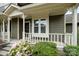 Inviting front porch with decorative white railing, complemented by colorful flowers and green shrubbery at 2756 Von Thuringer Ct, Charlotte, NC 28210