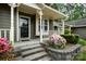 Charming home featuring a welcoming front porch with decorative columns, stairs, and beautiful landscaping at 2756 Von Thuringer Ct, Charlotte, NC 28210