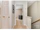 Upstairs hallway featuring neutral decor and view of a bedroom with dresser at 2756 Von Thuringer Ct, Charlotte, NC 28210
