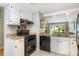 Bright kitchen with black appliances and a view to the backyard and patio at 2756 Von Thuringer Ct, Charlotte, NC 28210