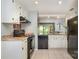 Well-lit kitchen featuring sleek black appliances and white cabinets at 2756 Von Thuringer Ct, Charlotte, NC 28210