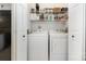 Practical laundry area with a modern washer and dryer and shelving for storage at 2756 Von Thuringer Ct, Charlotte, NC 28210