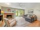 Cozy living room featuring a brick fireplace, hardwood floors, and a sliding glass door at 2756 Von Thuringer Ct, Charlotte, NC 28210