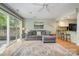 Open living room featuring hardwood floors, a gray sectional, and a view into the kitchen at 2756 Von Thuringer Ct, Charlotte, NC 28210