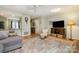 Spacious living room with hardwood floors, a TV, and a view into the kitchen at 2756 Von Thuringer Ct, Charlotte, NC 28210