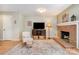 Comfortable living room with hardwood floors, brick fireplace, and ample natural light at 2756 Von Thuringer Ct, Charlotte, NC 28210