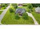 Expansive brick home with lush green lawn and mature trees on a well manicured lot from an aerial perspective at 3011 Patrick Place Cir, Clover, SC 29710