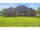 A house with a large, flat, manicured backyard, a covered back porch, and some playground equipment at 3011 Patrick Place Cir, Clover, SC 29710