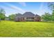 A house with a large, flat, manicured backyard, a covered back porch, and a trampoline at 3011 Patrick Place Cir, Clover, SC 29710