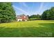 A sprawling backyard with lush green grass, a tall fence, and tree lined for privacy and outdoor fun at 3011 Patrick Place Cir, Clover, SC 29710