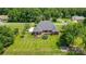 Spacious backyard featuring a well-maintained lawn, deck, trampoline, and dark metal perimeter fencing at 3011 Patrick Place Cir, Clover, SC 29710