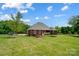 Expansive backyard with a well-maintained lawn, a trampoline, and a home with black fencing at 3011 Patrick Place Cir, Clover, SC 29710