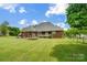 Large backyard with a well-kept lawn, a trampoline, and a charming patio, great for entertaining at 3011 Patrick Place Cir, Clover, SC 29710