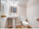 A well-lit powder room featuring a classic pedestal sink and toilet, perfect for guests at 3011 Patrick Place Cir, Clover, SC 29710