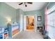 Stylishly decorated bedroom featuring a white crib, ceiling fan, rocker, and a colorful dresser at 3011 Patrick Place Cir, Clover, SC 29710