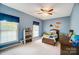 Cozy, blue bedroom with ceiling fan, and two windows at 3011 Patrick Place Cir, Clover, SC 29710