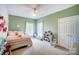 Bright and airy bedroom with a ceiling fan, two windows, and a comfortable bed at 3011 Patrick Place Cir, Clover, SC 29710