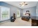 Cozy bedroom with natural light and neutral walls featuring a wooden bed frame and a small sitting chair at 3011 Patrick Place Cir, Clover, SC 29710