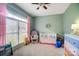 Stylishly decorated bedroom featuring a white crib, ceiling fan, rocker, and a colorful dresser at 3011 Patrick Place Cir, Clover, SC 29710