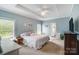 Tranquil bedroom featuring neutral paint, a tray ceiling, and lots of natural light at 3011 Patrick Place Cir, Clover, SC 29710