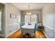 Cozy dining room with hardwood floors, bright window, and a charming light fixture at 3011 Patrick Place Cir, Clover, SC 29710
