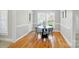 Bright dining room features hardwood floors, a round table, and large windows providing natural light at 3011 Patrick Place Cir, Clover, SC 29710