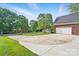 Expansive driveway leading to a brick home with a two-car garage and well-manicured lawn at 3011 Patrick Place Cir, Clover, SC 29710