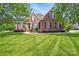 Inviting brick home with a lush green lawn and black shutters, showcasing classic curb appeal at 3011 Patrick Place Cir, Clover, SC 29710