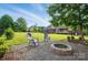 Stone fire pit with adirondack chairs on gravel, a nice spot for outdoor entertaining at 3011 Patrick Place Cir, Clover, SC 29710